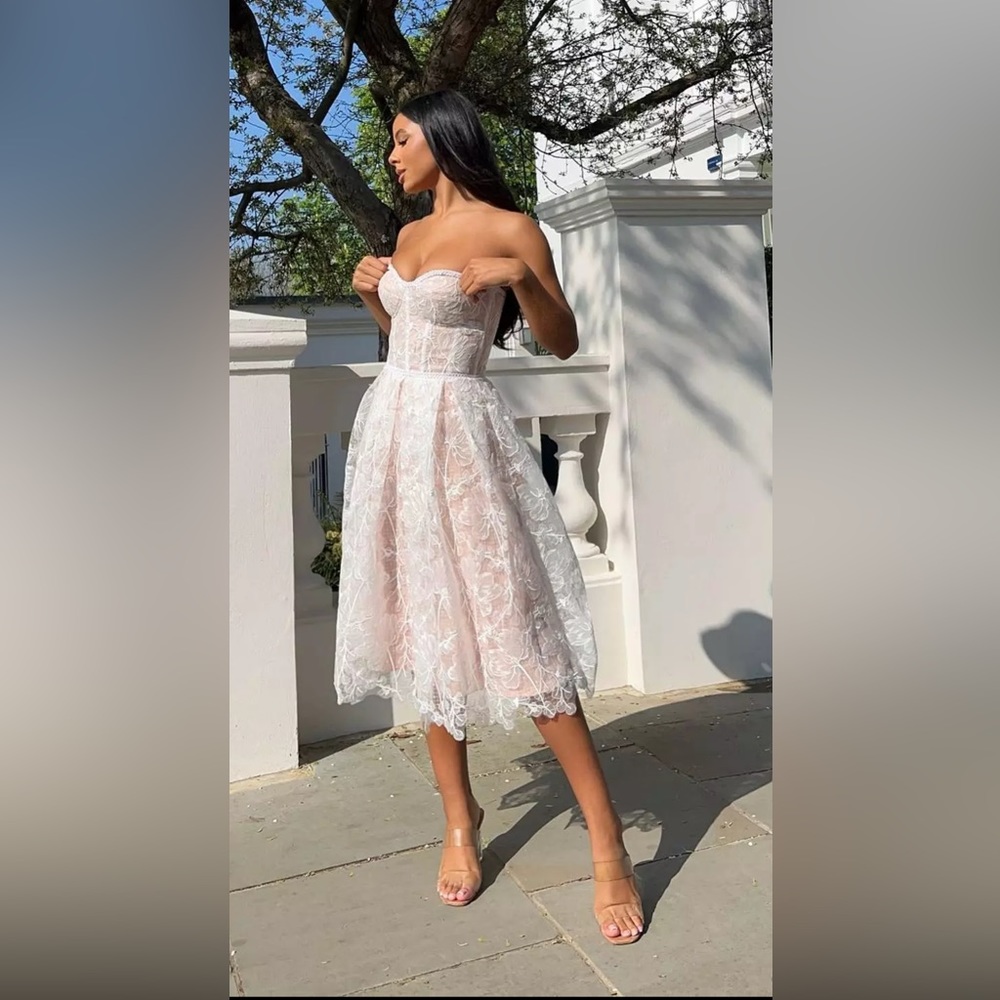Brand new white dress with tags. Looks very beautiful. It is not my size